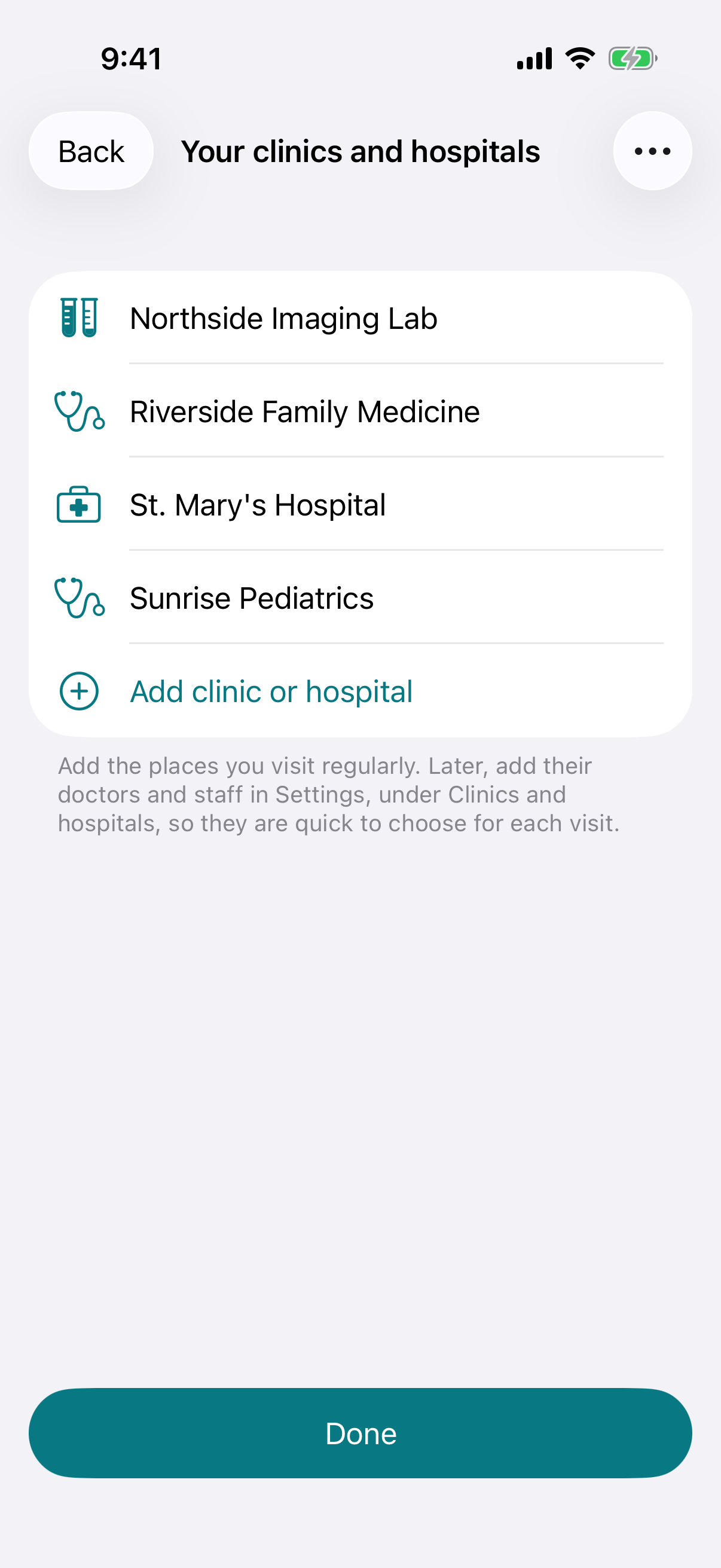 The first-launch setup in WellHeard on iPhone: a list of the person's clinics, hospital and lab, with a button to add another.